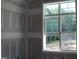 A window provides a view of the outdoor green space at 5900 Tranquil Cv, Youngsville, NC 27596