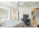 Upstairs bedroom with a modern ceiling fan, balcony access and black metal bedframe at 6 Newgate Ct, Durham, NC 27713