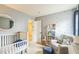 Cozy Bedroom space with calming colors, a crib, reading chair and star-themed wall accents at 6 Newgate Ct, Durham, NC 27713