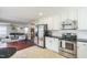 Open-concept kitchen and living area with stainless steel appliances and seamless flow for entertaining at 6 Newgate Ct, Durham, NC 27713