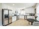 Modern kitchen featuring stainless steel appliances, white cabinetry, and a connected breakfast area at 6 Newgate Ct, Durham, NC 27713