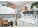 Functional laundry room featuring washer, dryer, shelving, storage baskets, and plant at 6 Newgate Ct, Durham, NC 27713