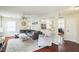 Living room with hardwood floors, large windows, and an open doorway to other living spaces in the home at 6 Newgate Ct, Durham, NC 27713