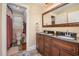 Bathroom with granite countertop vanity and framed mirror, and a separate toilet and shower area at 6035 Sentinel Dr, Raleigh, NC 27609
