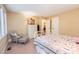 Calm bedroom featuring a bed with a patterned quilt, a white dresser, and a comfortable sitting area with chair at 6035 Sentinel Dr, Raleigh, NC 27609