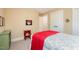 This bedroom includes a white metal bed frame with colorful bedding and an ornate red side table at 6035 Sentinel Dr, Raleigh, NC 27609