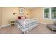 Bright bedroom featuring a metal bed frame, two side tables with lamps, and a window providing natural light at 6035 Sentinel Dr, Raleigh, NC 27609