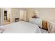 Inviting bedroom featuring a white bed, a dresser, and a doorway view to an attached bathroom at 6035 Sentinel Dr, Raleigh, NC 27609