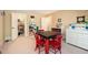 Bright bonus room features a red table with four chairs, white shelving, and a glimpse into a walk-in closet at 6035 Sentinel Dr, Raleigh, NC 27609
