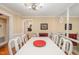 Elegant dining room with a large table, white chairs, and a mirrored wall, perfect for entertaining guests at 6035 Sentinel Dr, Raleigh, NC 27609