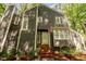 Close-up of the home's entry showing the front door, brick steps, and well-maintained landscaping at 6035 Sentinel Dr, Raleigh, NC 27609