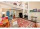 Open living room with fireplace, wooden floors, bright and colorful rug, and lots of natural light at 6035 Sentinel Dr, Raleigh, NC 27609