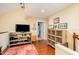 Bright, open living room featuring hardwood floors, a media center, and a doorway leading to another room at 6035 Sentinel Dr, Raleigh, NC 27609