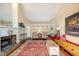 Bright living room featuring a fireplace, hardwood floors, and an abundance of natural light at 6035 Sentinel Dr, Raleigh, NC 27609
