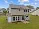Well-maintained back exterior with a spacious yard and sliding glass door at 612 Quartz Dr, Durham, NC 27703