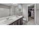 Bathroom featuring double sinks, modern fixtures, and a walk-in closet at 612 Quartz Dr, Durham, NC 27703