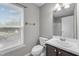 Cozy bathroom features a window, single sink vanity, and toilet at 612 Quartz Dr, Durham, NC 27703