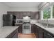 Modern kitchen with stainless steel appliances and granite countertops at 612 Quartz Dr, Durham, NC 27703