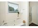 Relaxing bathroom featuring a large soaking tub and natural light from window at 6737 Vernie Dr, Raleigh, NC 27603