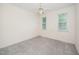 Bright bedroom with neutral walls, carpet flooring, and windows with lush green views at 6737 Vernie Dr, Raleigh, NC 27603