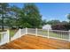 Wood deck with white railing overlooking a lush green yard at 6737 Vernie Dr, Raleigh, NC 27603