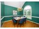 Elegant dining room boasting a large arched window, chandelier, and green walls at 6737 Vernie Dr, Raleigh, NC 27603
