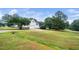 Long driveway leading to the house, surrounded by lush green lawns and mature trees at 6737 Vernie Dr, Raleigh, NC 27603