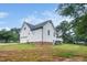 Exterior side view of a white siding home with a backyard at 6737 Vernie Dr, Raleigh, NC 27603