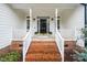 Welcoming front porch with brick stairs and white trim at 6737 Vernie Dr, Raleigh, NC 27603