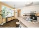Bright kitchen with white cabinets, updated appliances, and a breakfast bar seating area at 6737 Vernie Dr, Raleigh, NC 27603
