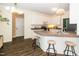Kitchen with a breakfast bar, white cabinetry, and modern appliances at 6737 Vernie Dr, Raleigh, NC 27603