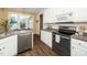 Modern kitchen with stainless steel appliances, breakfast nook and hardwood flooring at 6737 Vernie Dr, Raleigh, NC 27603