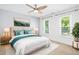 Bright bedroom with a ceiling fan, large windows, and contemporary decor at 6912 Baywood Dr, Raleigh, NC 27613