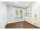 Charming breakfast nook featuring natural light, hardwood floors, and built in white cabinetry at 6912 Baywood Dr, Raleigh, NC 27613