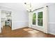 Bright dining room area with hardwood floors and chandelier fixture adjacent to a modern kitchen at 6912 Baywood Dr, Raleigh, NC 27613