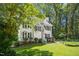 Traditional home with mature trees, attractive landscaping, neutral siding and black shutters at 6912 Baywood Dr, Raleigh, NC 27613