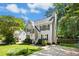 Charming two-story home featuring a well-manicured lawn, neutral siding and black shutters under a sunny sky at 6912 Baywood Dr, Raleigh, NC 27613