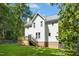 Exterior view of the home with a wood deck, stairs, and green grass at 6912 Baywood Dr, Raleigh, NC 27613