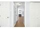 Hallway view into the living room with a fireplace and built in shelving at 6912 Baywood Dr, Raleigh, NC 27613