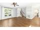 Inviting living room with hardwood floors, ceiling fan, stairs to the second story, and bright natural light at 6912 Baywood Dr, Raleigh, NC 27613