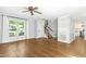 Comfortable living room with hardwood floors, ceiling fan, and staircase leading to upper level at 6912 Baywood Dr, Raleigh, NC 27613