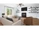 Cozy living room featuring a fireplace, ceiling fan and sliding glass doors to a patio area at 6912 Baywood Dr, Raleigh, NC 27613