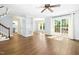 Spacious living room with hardwood floors, ceiling fan and sliding glass doors to a rear patio at 6912 Baywood Dr, Raleigh, NC 27613