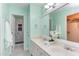 Bright bathroom with double sinks, white cabinets, and a view of the shower and walk-in closet at 7 Hitching Rack Ct, Durham, NC 27713