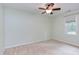 Empty bedroom featuring a ceiling fan, light green walls, and a window with blinds at 7 Hitching Rack Ct, Durham, NC 27713