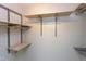 Walk-in closet with light wood shelves and metal railing for hanging clothes at 7 Hitching Rack Ct, Durham, NC 27713