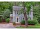 Charming two-story home with gray siding, dark shutters, and mature landscaping at 7 Hitching Rack Ct, Durham, NC 27713