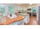 Bright kitchen featuring white cabinets, a kitchen island, and stainless steel appliances at 7 Hitching Rack Ct, Durham, NC 27713