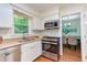 Well-appointed kitchen with white cabinets, granite counters, and stainless steel appliances at 7 Hitching Rack Ct, Durham, NC 27713