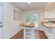 Open kitchen with white cabinets, granite countertops, hardwood floors, and access to the yard at 7 Hitching Rack Ct, Durham, NC 27713